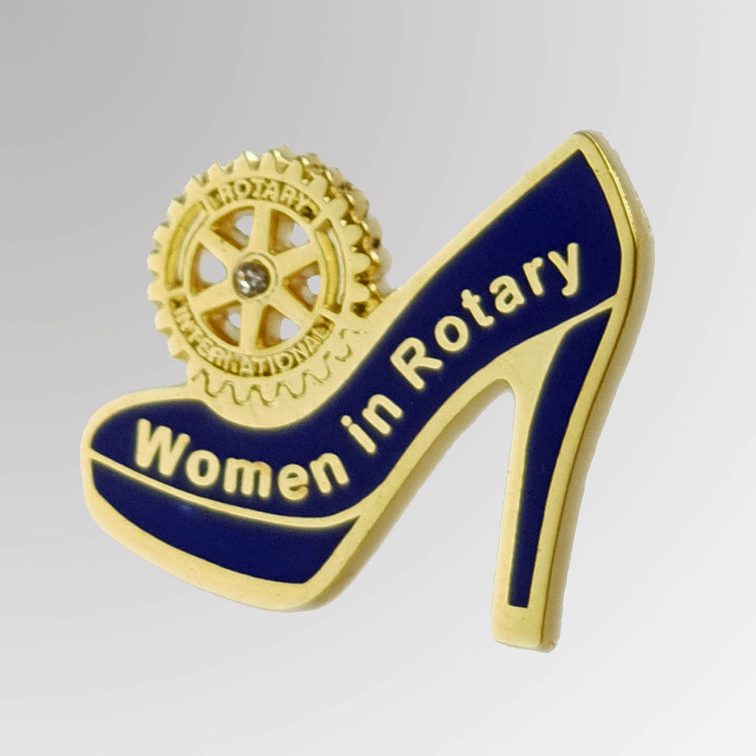 A gold-plated pin featuring a high heel design, celebrating women in Rotary with the Mark of Excellence, available with a butterfly clasp or magnet attachment.