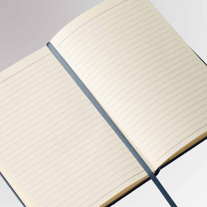 Close-up of the Rotary notebook’s cream-colored lined pages with a matching ribbon bookmark.