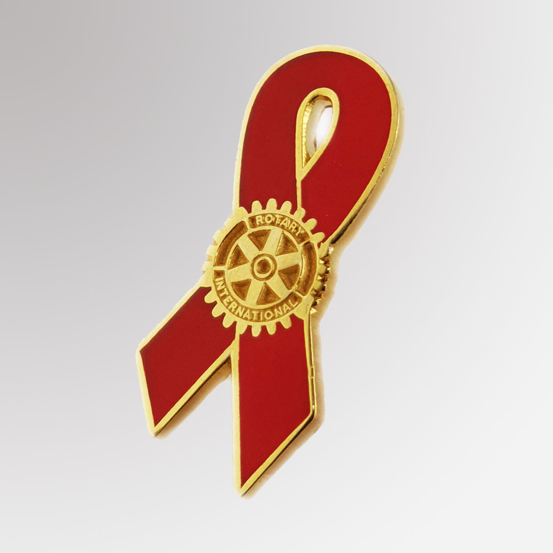 A red ribbon with Rotary International logo AIDS Awareness pin with a polished metal finish, symbolizing support and solidarity in the fight against HIV/AIDS.