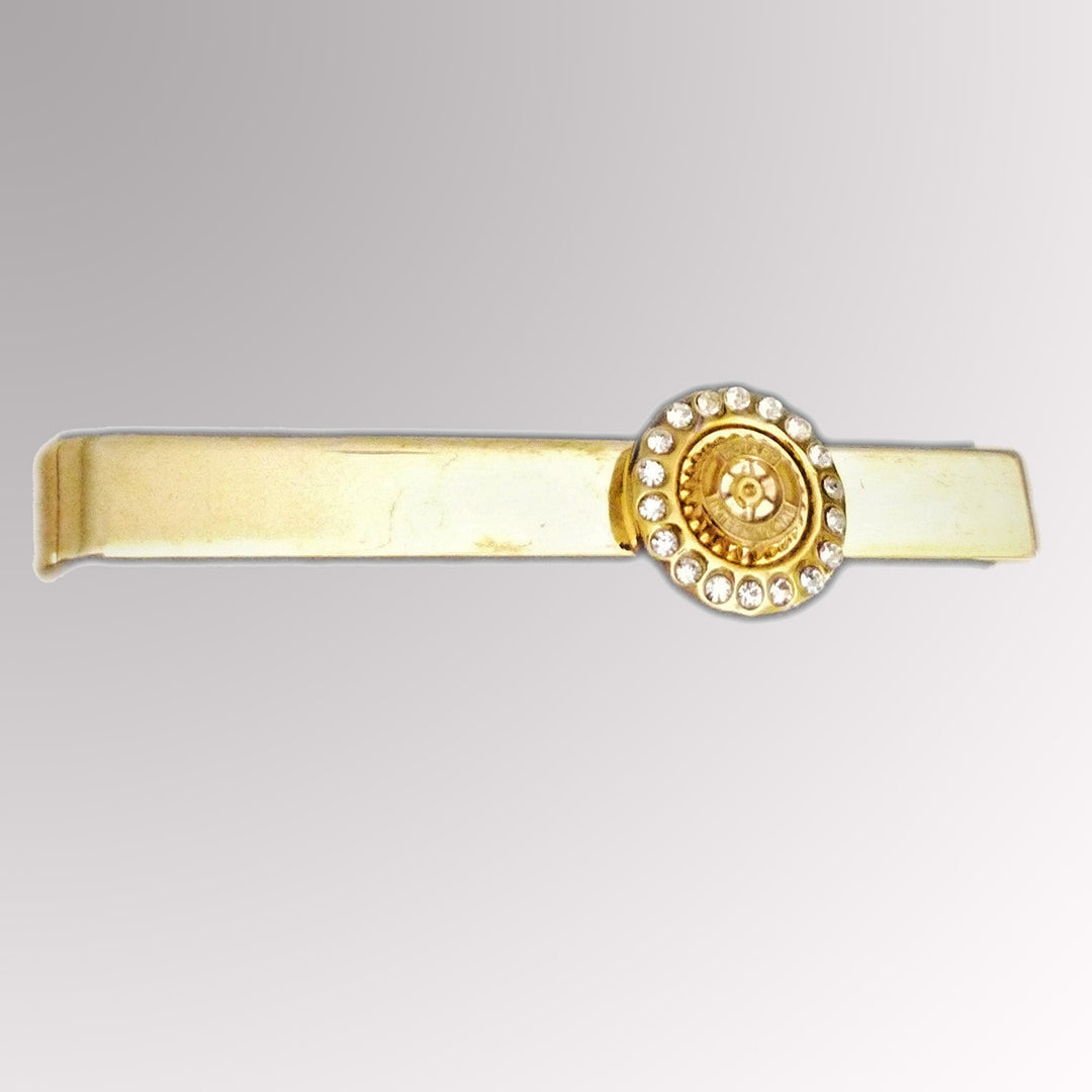 A gold-plated tie clip featuring Rotary International's Mark of Excellence with white imitation stones.