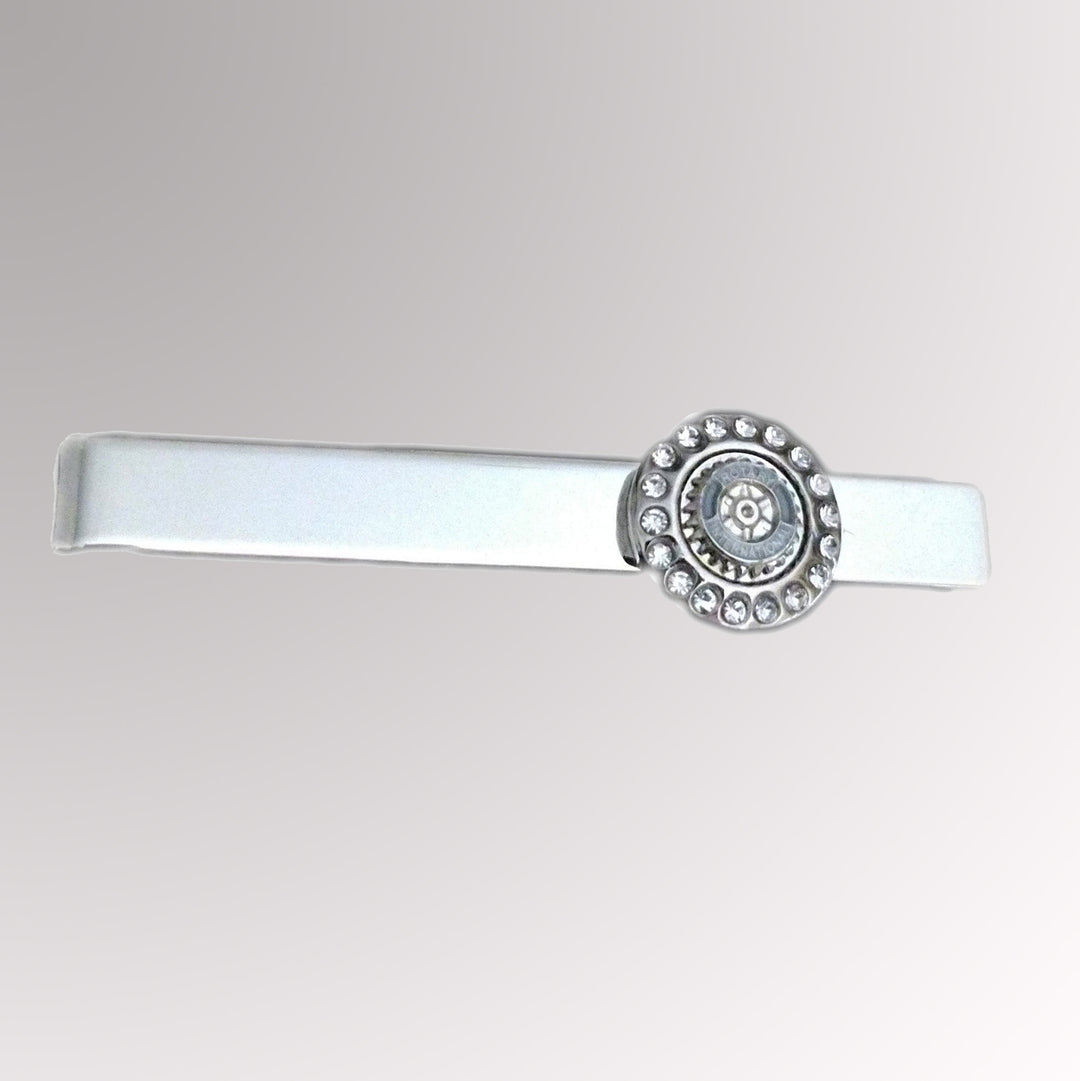 A silver finish tie clip featuring Rotary International's Mark of Excellence with white imitation stones.