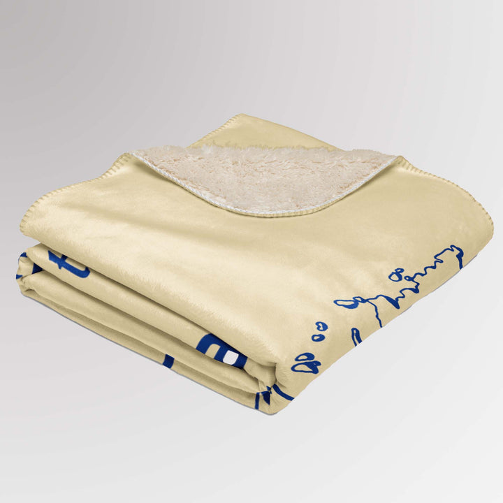 Neatly folded cream-colored Rotary sherpa blanket with part of the map and “Together We Connect the World” message visible, along with sherpa lining.