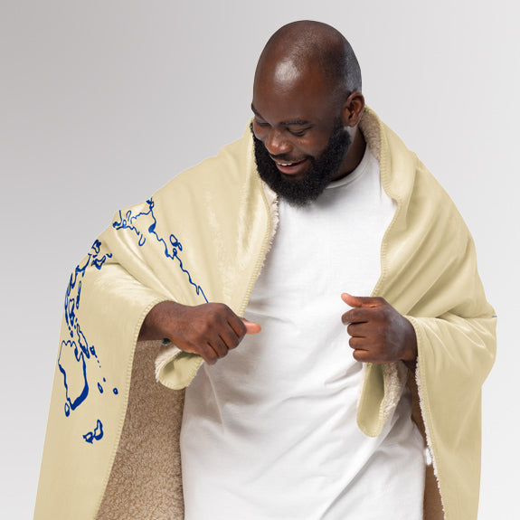 Man opening the Rotary sherpa blanket to reveal the sherpa lining and the printed world map with the message “Together We Connect the World.”