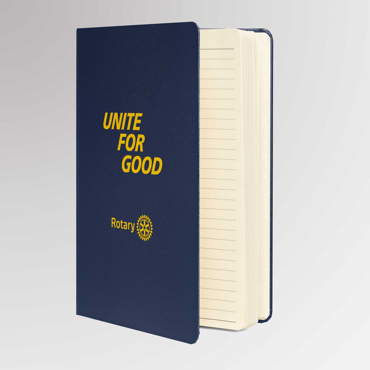 Angled view of the “Unite for Good” Rotary notebook showing its cream-colored pages and hardcover binding.