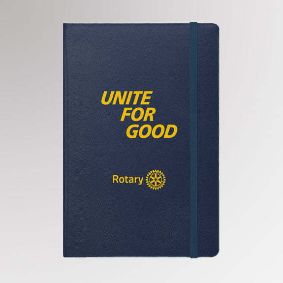 Rotary “Unite for Good” notebook with gold foil text and Rotary International Masterbrand logo on a navy blue hardcover.