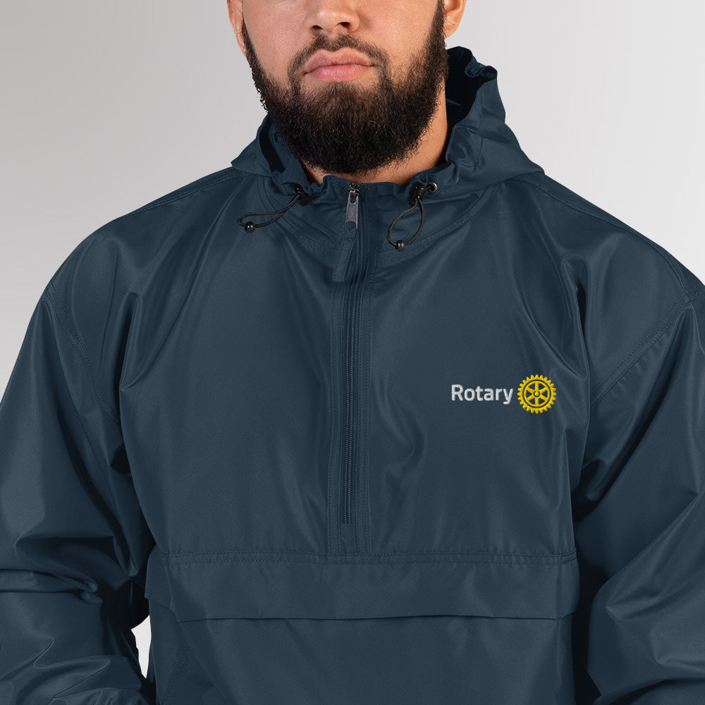 Close-up of the chest area showing the simplified Rotary Masterbrand logo embroidery on the navy Champion jacket.