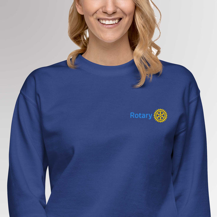 Female model wearing the high-quality premium blue colored sweatshirt featuring the embroidered Rotary International Master Brand logo by Awards California