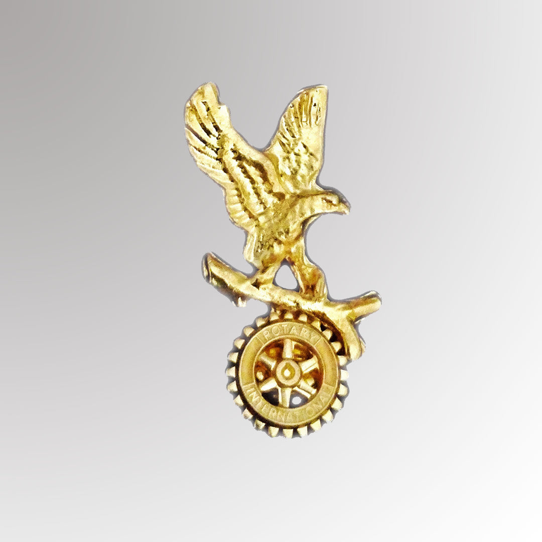 A polished metal Eagle Pin featuring intricate detailing and Rotary International's Mark of Excellence logo.