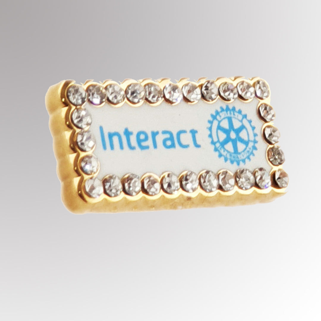 A high-quality Fancy Interact Member Pin featuring the New Interact Club logo with a polished finish.