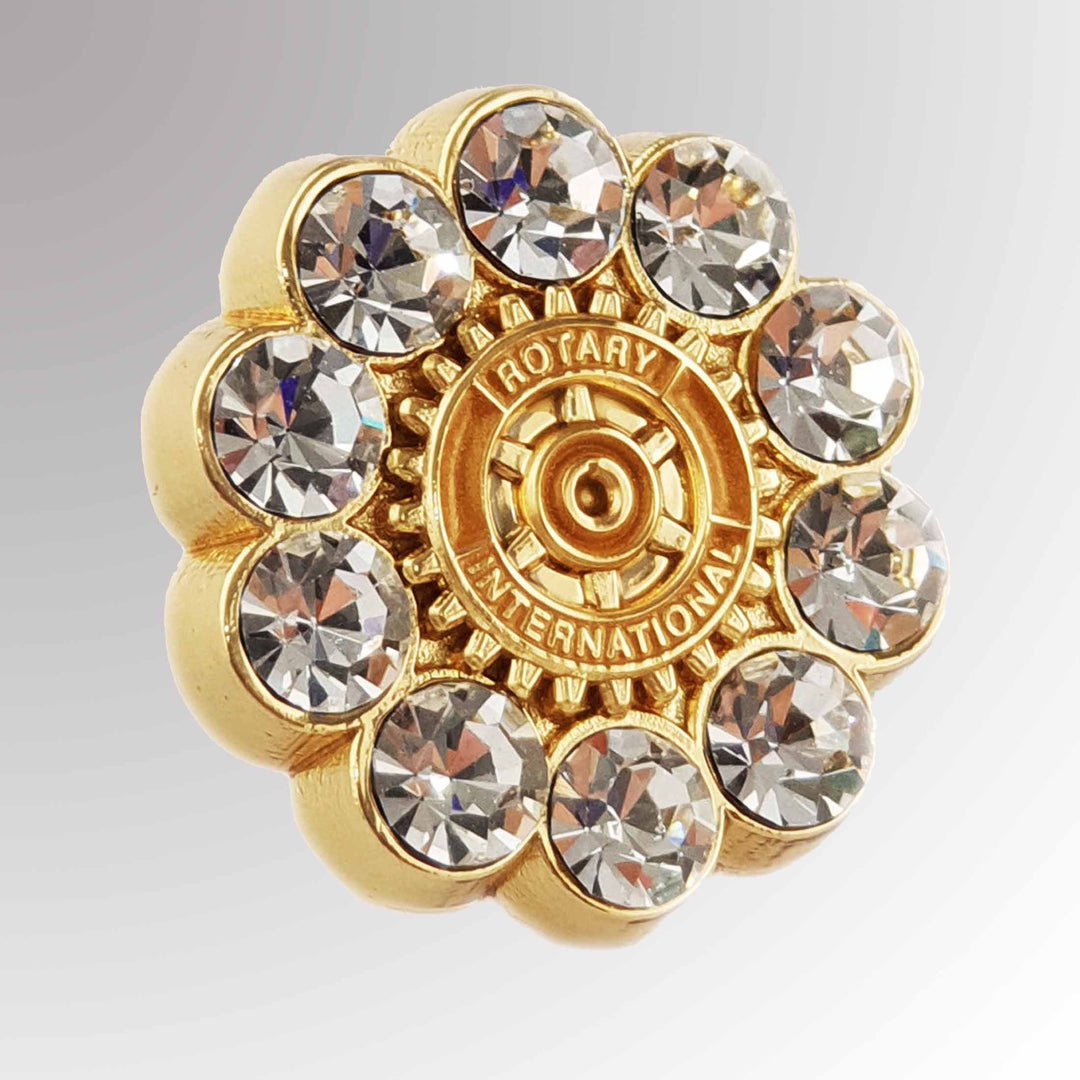 A gold-plated Fancy White Stone Pin featuring Rotary International's Mark of Excellence logo with 10 massive white imitation stones.