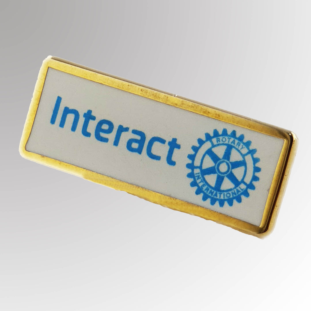 A gold-plated Interact Member Pin featuring the New Interact Club logo.