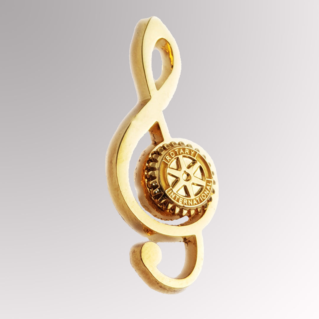 A gold-plated Musical Rotarian Pin featuring Rotary International's Mark of Excellence logo.