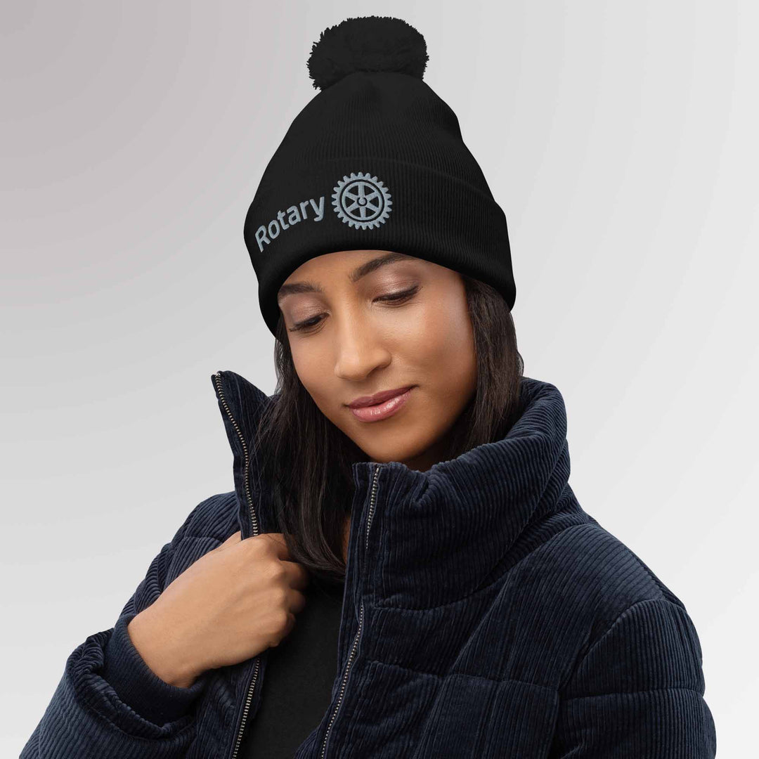 Female model wearing a high-quality black beanie with the Rotary International Master Brand logo embroidered, blending comfort and elegance