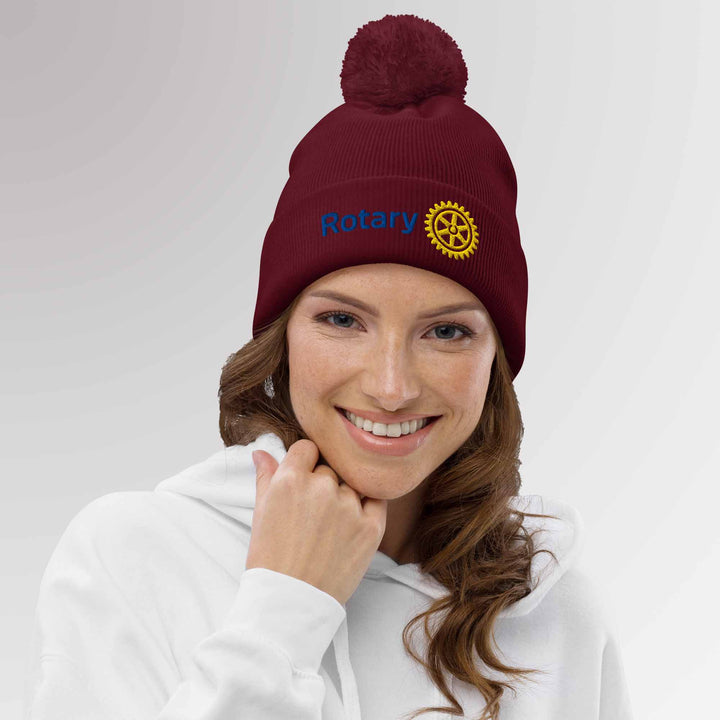 Female model wearing a high-quality blue cuffed beanie with the Rotary International Master Brand logo embroidered, combining comfort and sophistication