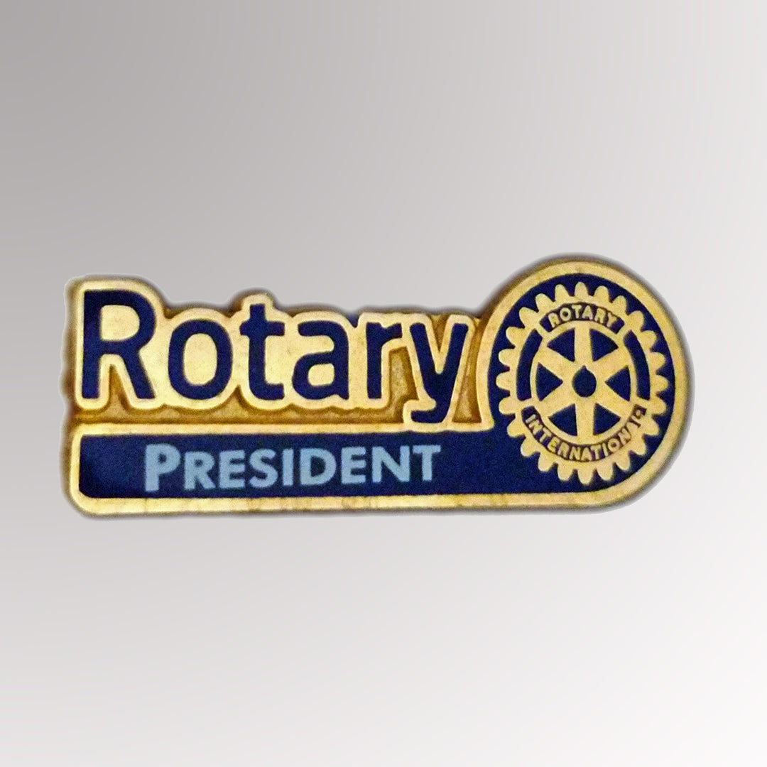 A gold-plated Club President Pin featuring Rotary International's Master Brand logo.