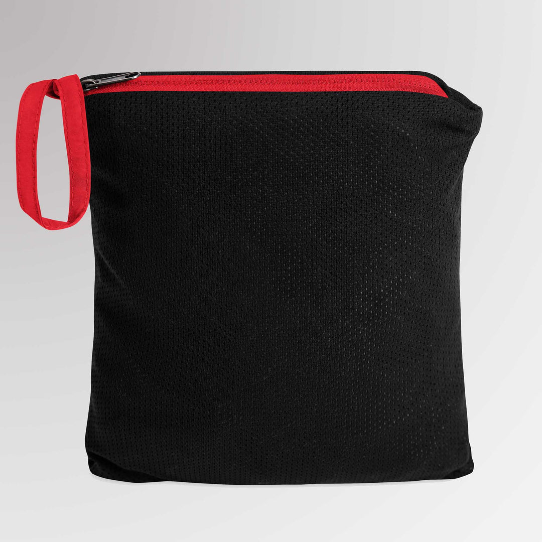 Red-accented black zippered pouch containing the folded Champion jacket, demonstrating the packable storage feature.
