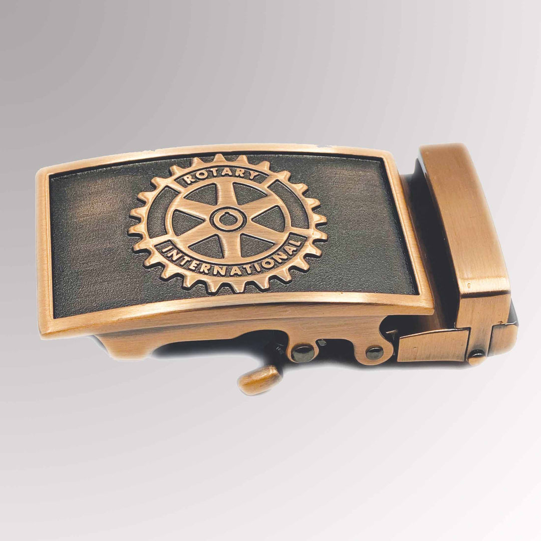 A belt buckle with an antique copper finish featuring Rotary International's Mark of Excellence logo, designed to fit most 1.5" wide belts.