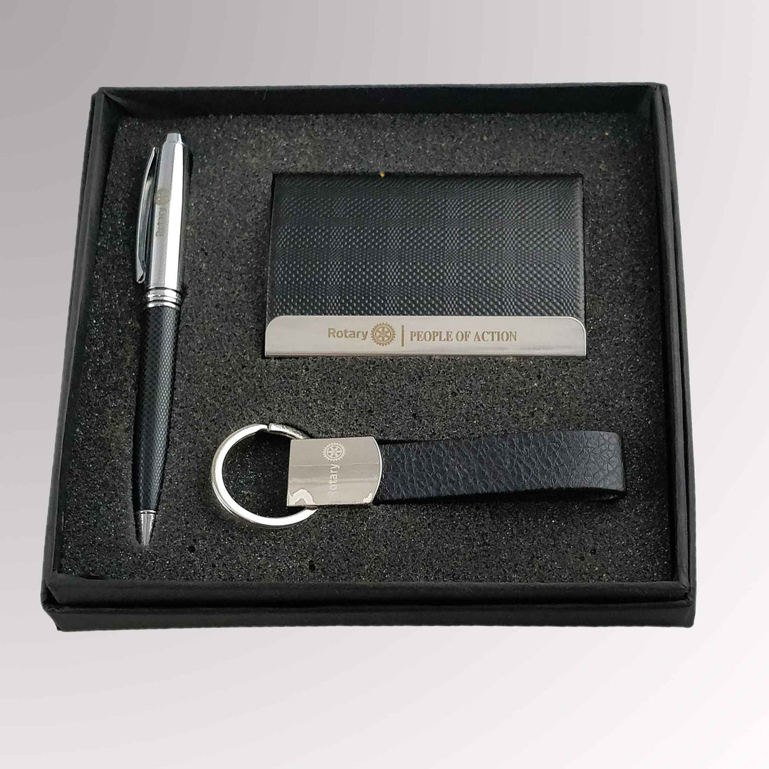 A Rotary Gift Set featuring a key chain, ballpoint pen, and card holder with Rotary International's Master Brand logo.