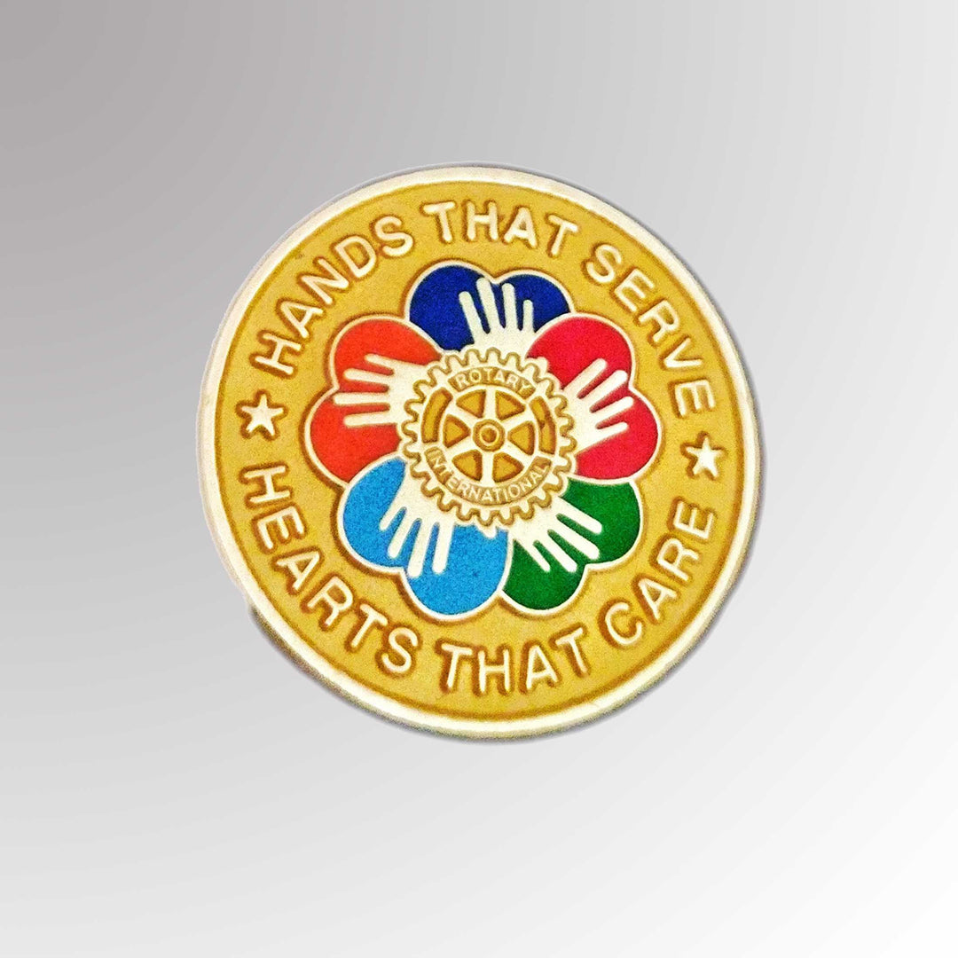 A gold-plated pin featuring Rotary International's Mark of Excellence logo and the "Hands That Serve, Hearts That Care" design.