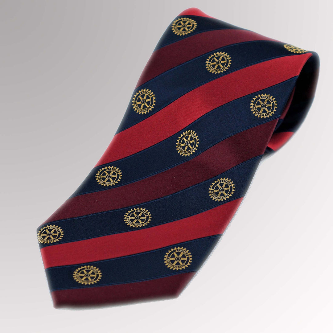 A woven silk tie featuring maroon, red, and blue stripes with Rotary International's Gold Mark of Excellence.