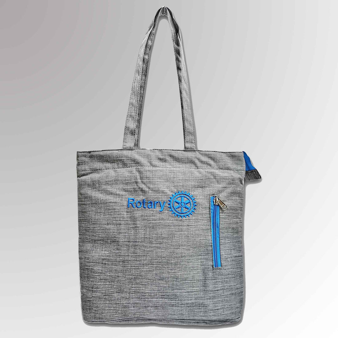 A durable laptop/tablet tote bag featuring Rotary International's Master Brand logo and high-quality stitching.