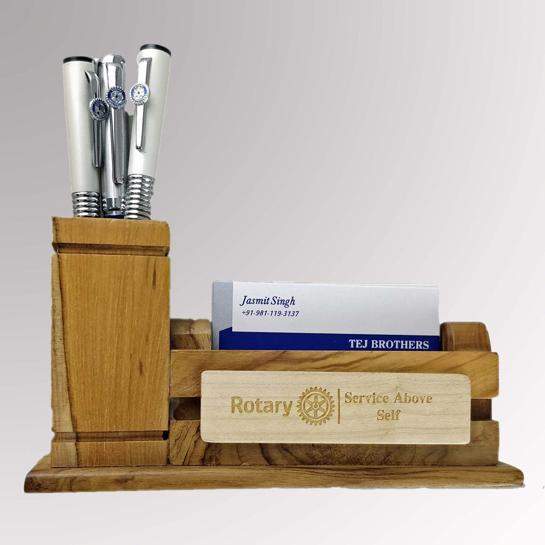 A wooden pen and card stand featuring Rotary International's Master Brand logo.