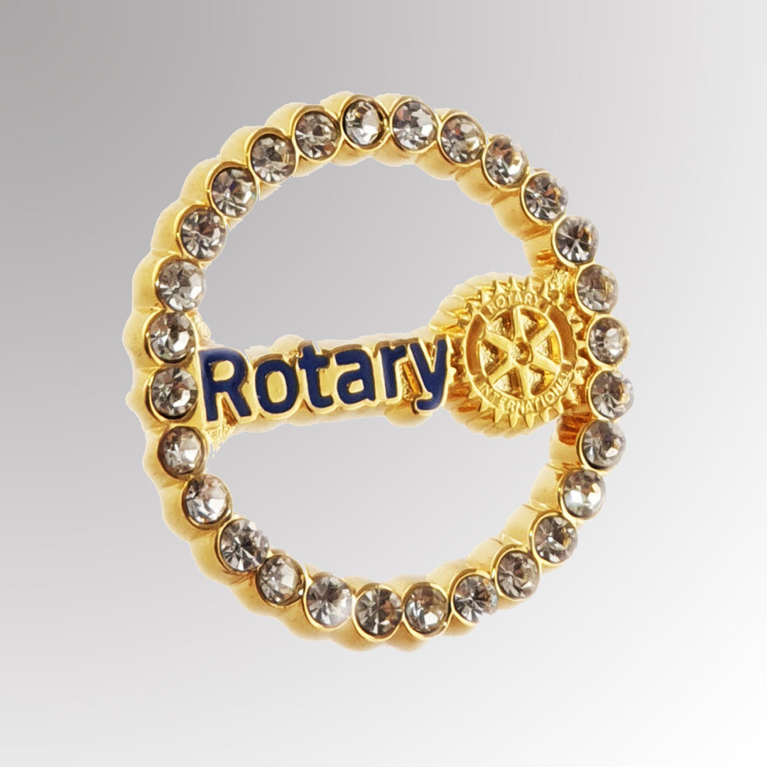 A polished metal Fancy Master Brand Pin featuring Rotary International's Master Brand logo with white-colored imitation stones.