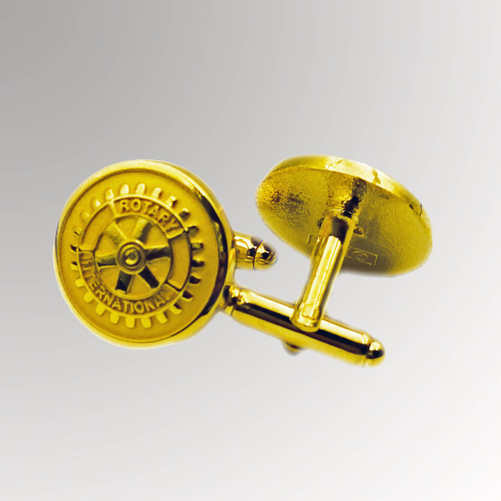 A pair of gold-plated Rotary Cuff Links with a matte background featuring Rotary International's Mark of Excellence logo.