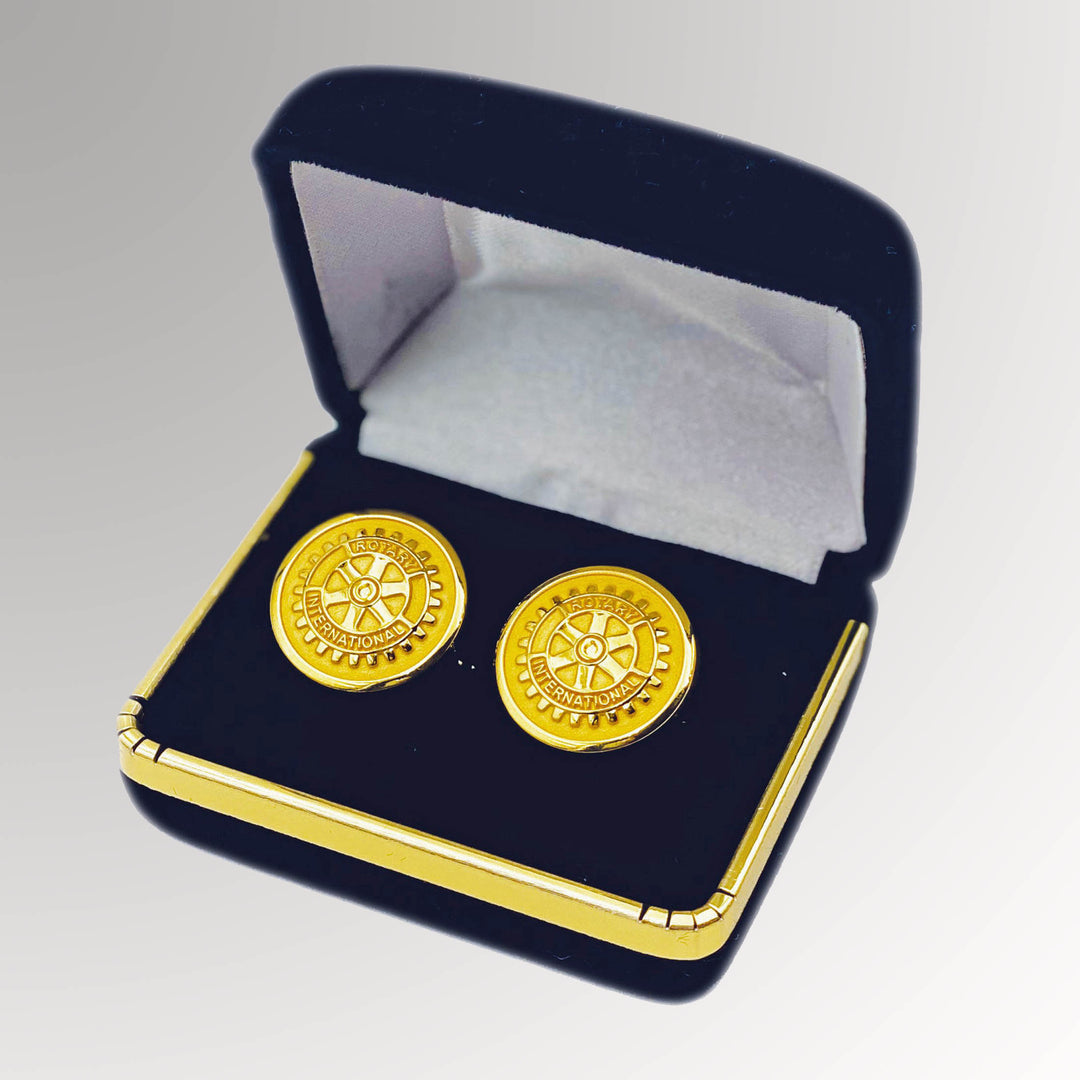 A pair of gold-plated Rotary Cuff Links with a matte background with box featuring Rotary International's Mark of Excellence logo.