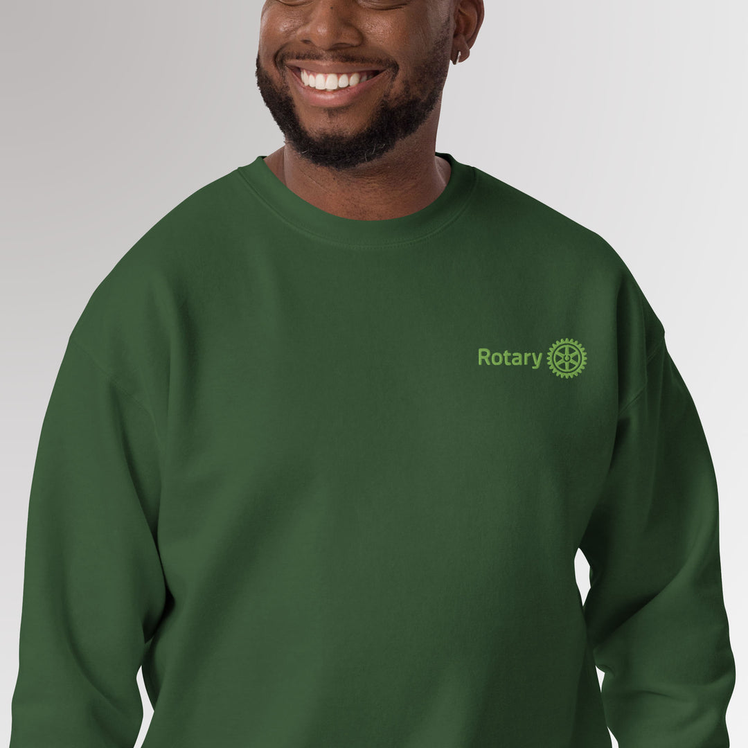 Male model showcasing forest green colored high-quality unisex premium sweatshirt with Rotary International Master Brand logo embroidered by Awards California