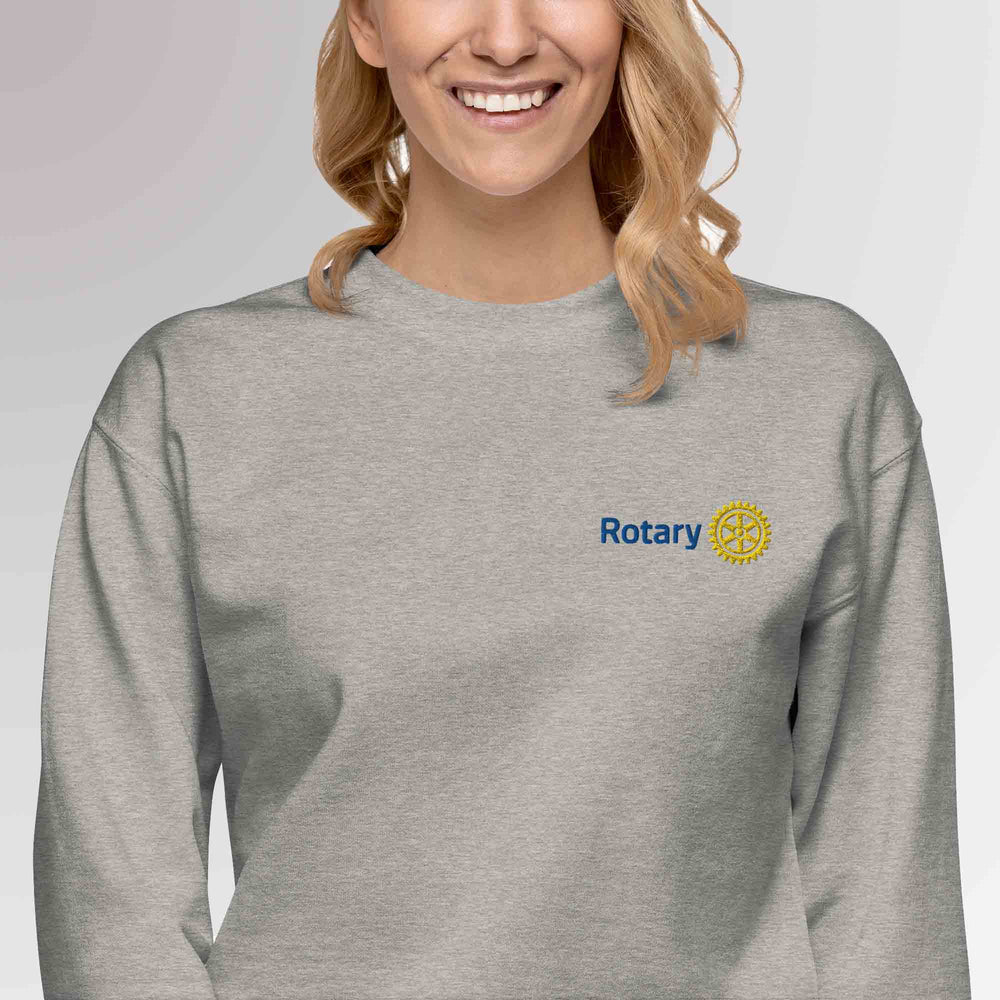 Female model wearing grey colored high-quality premium sweatshirt featuring the embroidered Rotary International Master Brand logo by Awards California