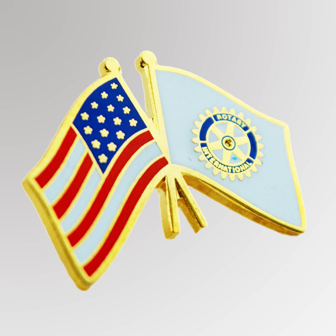 A gold-plated USA Flag Pin featuring the American and Rotary flags with the traditional Rotary logo.